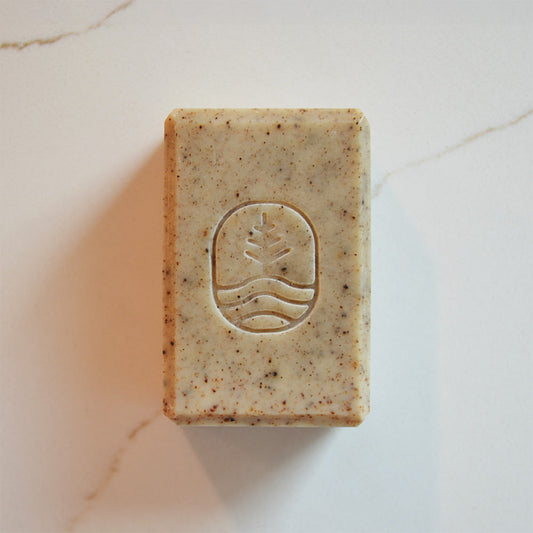 Tsoji mountain green tea soap bar front size with pine floating on water Tsoji logo