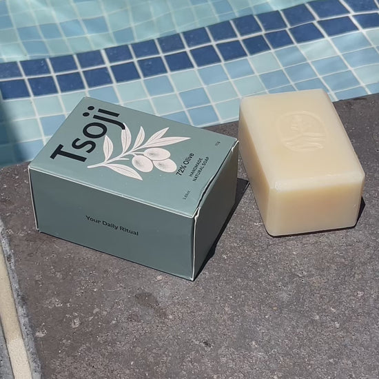 A video shot next to a pool in natural light showing Tsoji handmade all natural soaps Tsoji mountain green tea soap bar, Tsoji Ginseng Vitality soap bar, Tsoji Moongrass Harmony soap bar, Tsoji Shou Wu and Ginger soap bar, and Tsoji 72% Olive Soap bar one by one