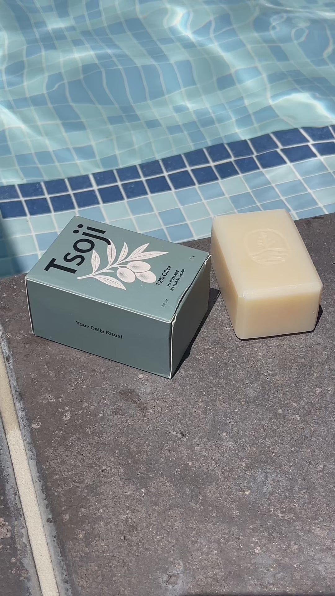 A video shot next to a pool in natural light showing Tsoji handmade all natural soaps Tsoji mountain green tea soap bar, Tsoji Ginseng Vitality soap bar, Tsoji Moongrass Harmony soap bar, Tsoji Shou Wu and Ginger soap bar, and Tsoji 72% Olive Soap bar one by one